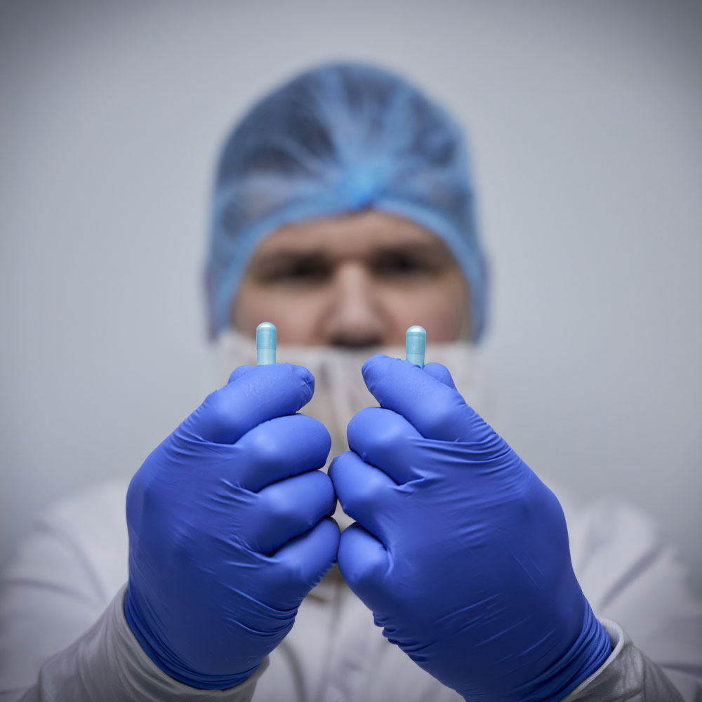 Man holding capsules